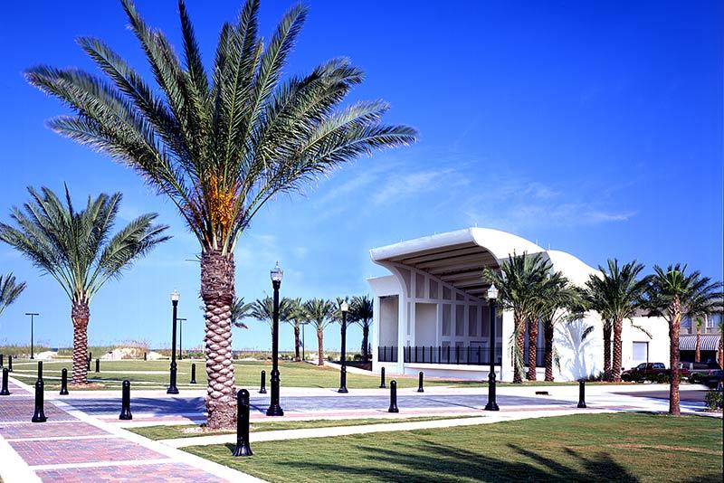 Exterior photo of Sea Walk Pavilion. Palm trees line either side of the venue. Brick sidewalks lead all around the location.